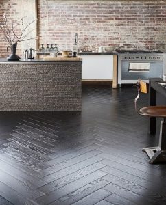 Black Authentic herringbone laminate flooring in a commercial kitchen