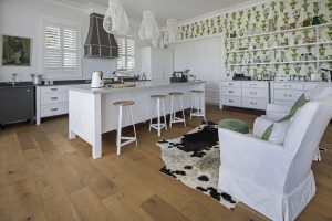 oak wood flooring in kitchen with green wallpaper