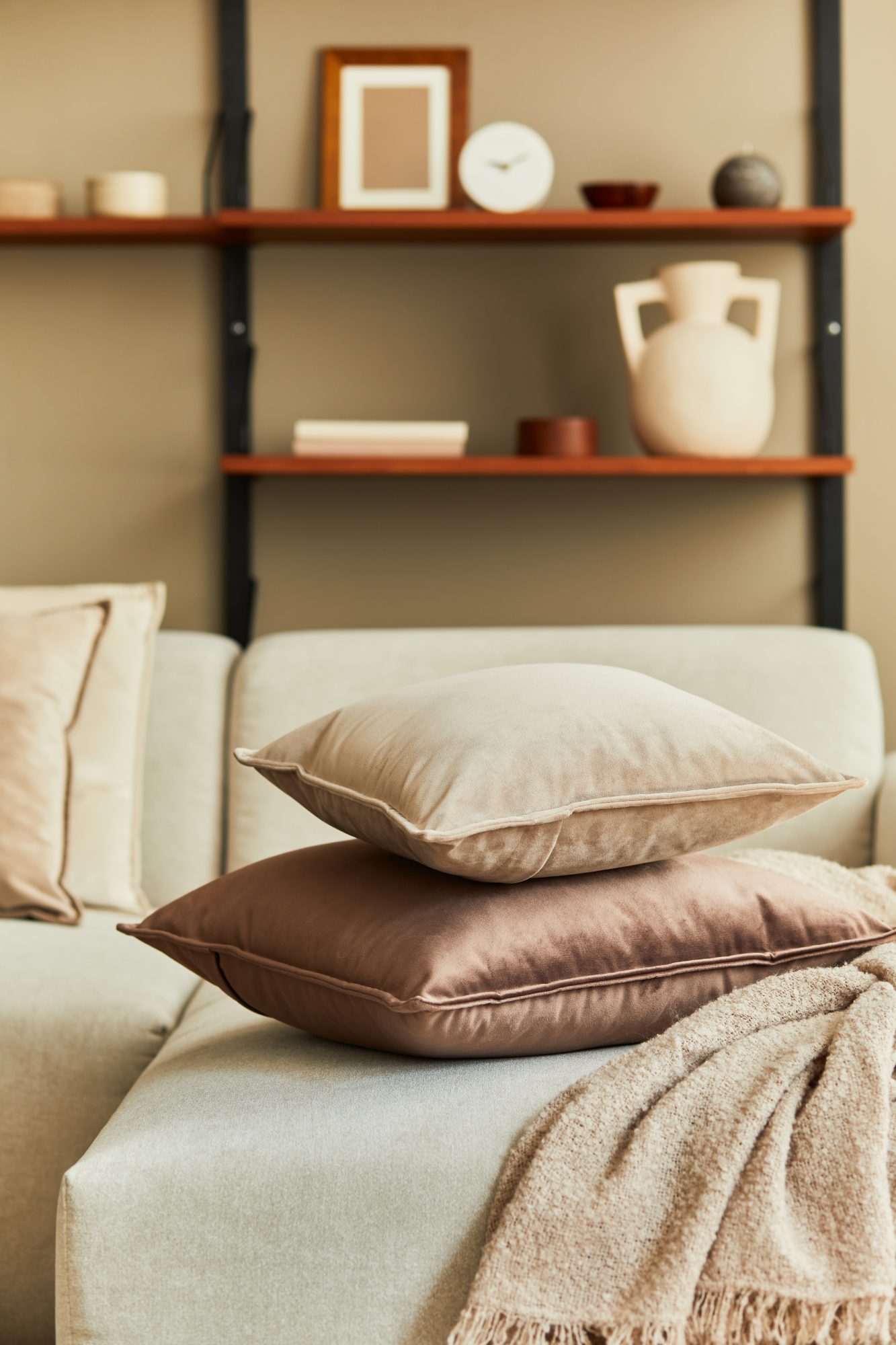 Stylish concept of living room interior with design beige sofa,